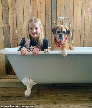 Daughter Ella enjoying the couple’s new bathroom with dog Alfie.