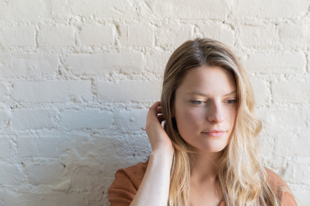 Woman Tucking Hair Behind Ear